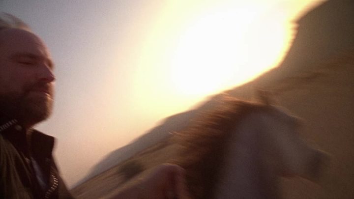Motion-blurred whip of sun and sleeve as the camera leaves the tripod