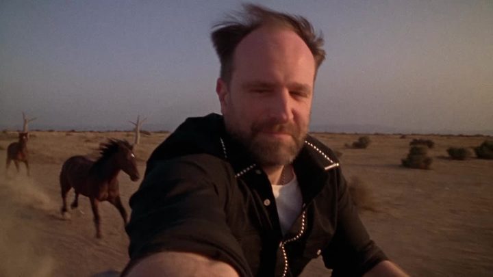 Selfie at arm's length, hair in the wind